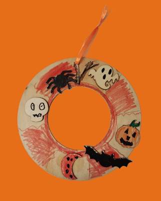 A handmade wreath with a spider and pumpkin